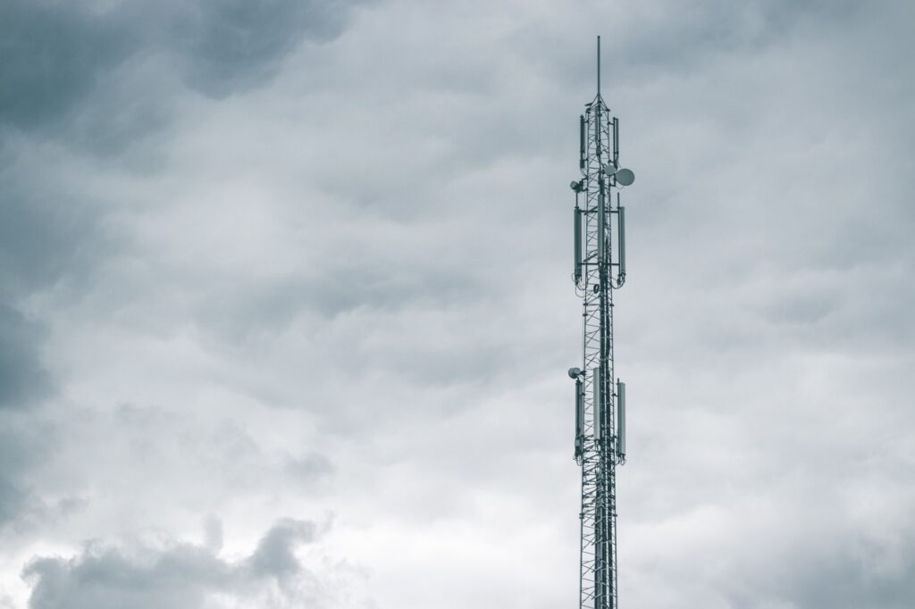 Communications tower coming out of grey clouds
